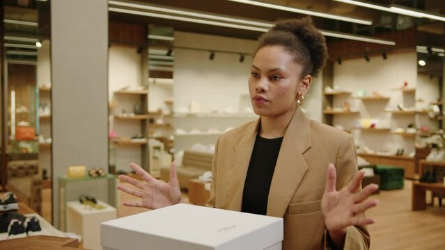 A stylish African American young woman came to the store to exchange the shoes she bought