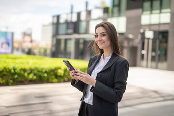 Businesswoman using a smartphone outdoor