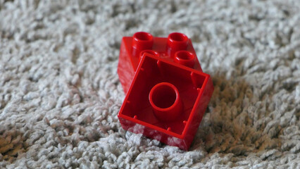 Mix of Colourful Pieces of Bricks sitting on mat indoors © peter