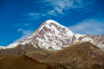 Snowy mountain peak against cloud