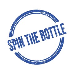 SPIN THE BOTTLE text written on blue grungy round stamp.