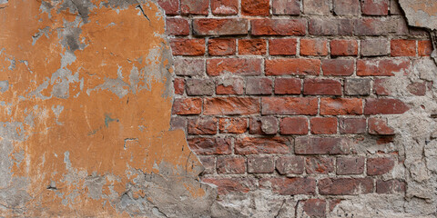 Dirty old red brick wall with cracks and orange paint. 