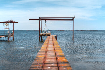 Wooden piers and boats for the oyster farm in Etang de Thau in South France