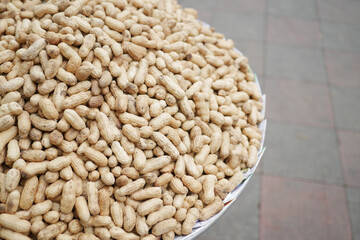 Processed pea nuts in a bowl on table top down .