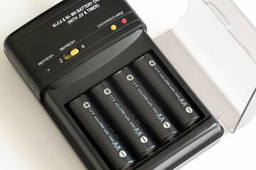 Charge and discharge adapter of Nickel Cadmium and Nickel Magnesium batteries. 1.2 Volt and 2450 milliamp AA batteries are charging.