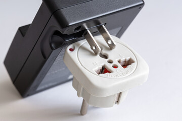 Universal plugs, travel adapter on an isolated white background and charging adapter with American...