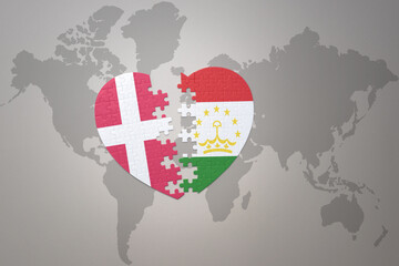 puzzle heart with the national flag of tajikistan and denmark on a world map background. Concept.