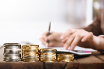 Elderly woman wrinkled hands count receipts with calculator. Lack of money.