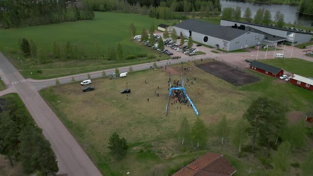 The start of Uka Pain 50 miles trail run. Drone footage forward dolly following the runners from the starting line.