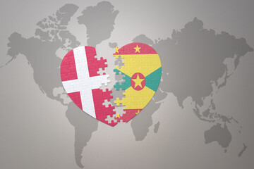 puzzle heart with the national flag of grenada and denmark on a world map background. Concept.