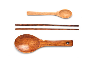 Set of wooden spoons and chopsticks isolated on white background.