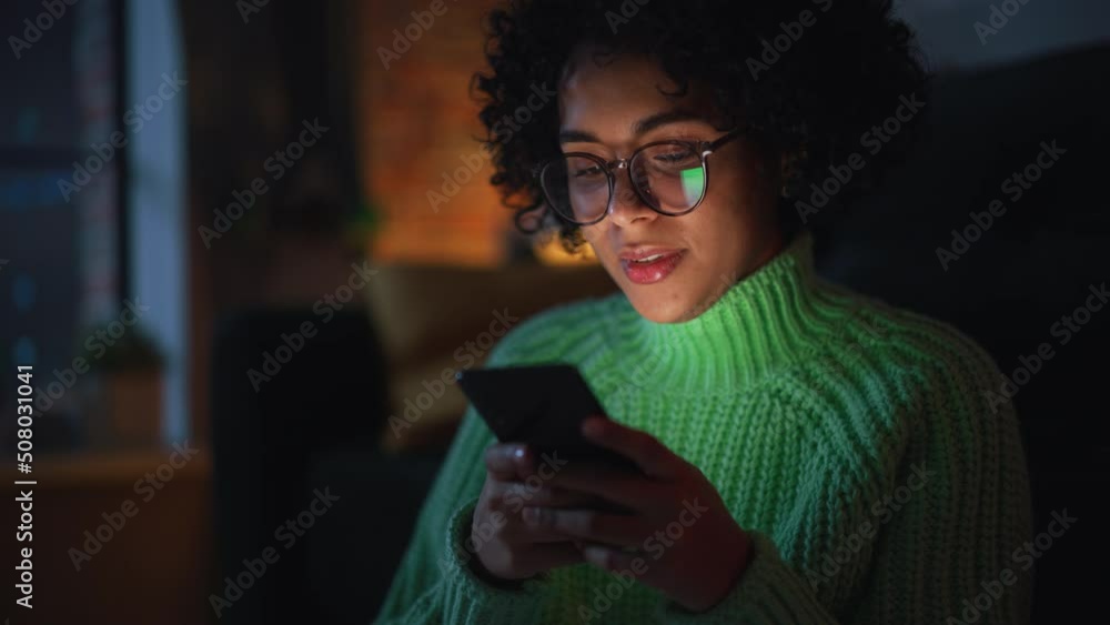 Poster multiethnic woman using smartphone while resting at home. black female blogger creating content and 