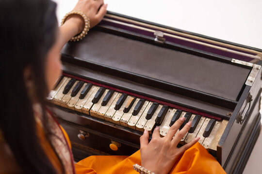 Close-up view of woman playing harmonium