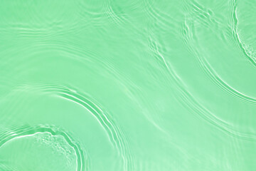 Transparent green clear water surface texture with ripples, splashes. Abstract nature background...