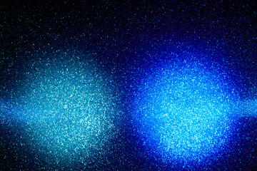 On a gradient dark blue background in fine grain clouds of light blue and light