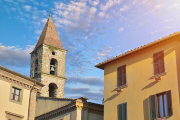 Fototapeta na wymiar Close-up of colorful buildings, bell tower and rooftops in a blue sunny day at Umbertide, a gracious little town near Perugia, Italy