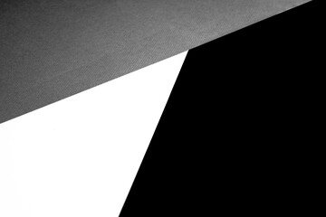 Black white and grey papers forming triangle shape textured background