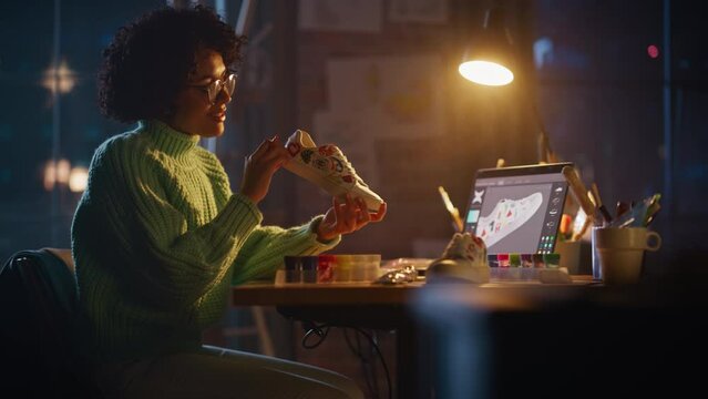 Cinematic Shot of Multiethnic Woman Enjoying of Her Work while Creating Hand Craft Shoe Late at Evening. Colorful Wild Brave Design of Sneakers Concept. Slow Motion