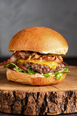 burger with meat, burger on a wooden table, juicy burger with different fillings