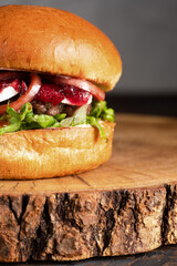 burger with meat, burger on a wooden table, juicy burger with different fillings