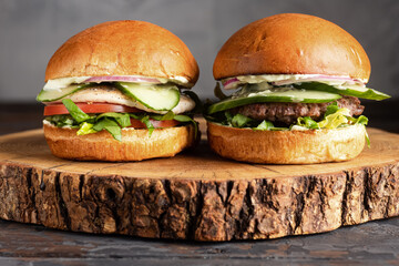 burger with meat, burger on a wooden table, juicy burger with different fillings