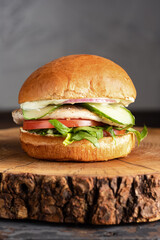 burger with meat, burger on a wooden table, juicy burger with different fillings
