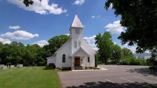 aerial through tree branches to reveal church chapel near abingdon and damascus virginia