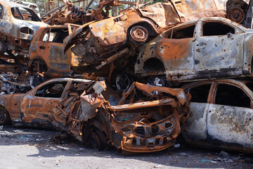 rusty burnt cars in Irpen, after being shot by Russian military and missile. Russia's invasion. war...