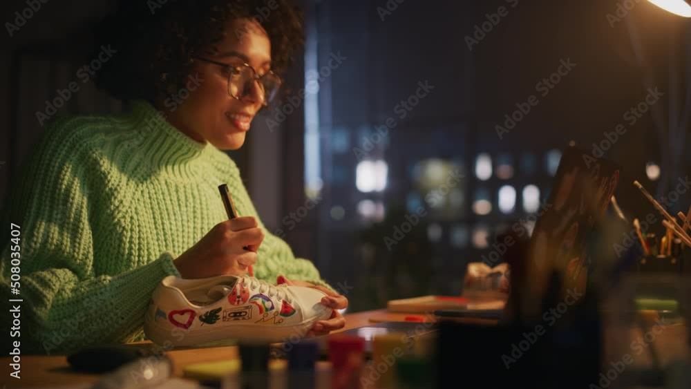 Aufkleber creative black female designer applying her own patterns on shoe by prototype of 3d model at laptop 