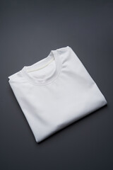 Folded t-shirt on a gray background, top view