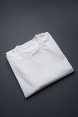 Fototapeta premium Folded t-shirt on a gray background, top view