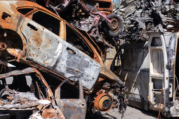 car graveyard. Burnt and blown up car. Cars damaged after shelling from russian invasion. War...