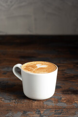Coffee, cappuccino coffee on a wooden background