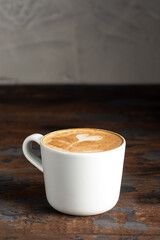 Coffee, cappuccino coffee on a wooden background