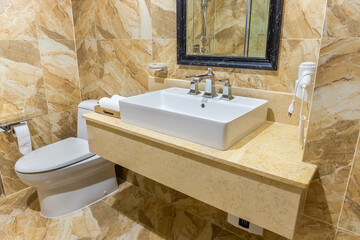 Washbasin with mirror, towels and handkerchiefs with shampoo, soap and hair dryer.