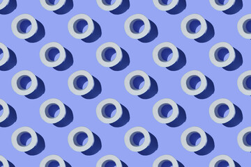 Seamless Pattern made of Toilet paper rolls isolated on blue background. The concept of hygiene. Pandemic panic concept.