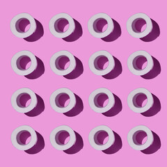 Fototapeta premium Pattern made of Toilet paper rolls isolated on pink background. New Corona virus infection background. Pandemic panic concept.