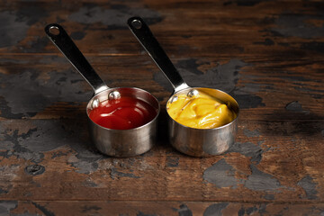 Cheese sauce, mustard, sour cream, tomato, sweet and sour sauce on a wooden background