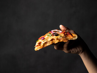 Delicious sliced vegetable pizza with isolated black background. Ready to eat.