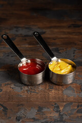 Cheese sauce, mustard, sour cream, tomato, sweet and sour sauce on a wooden background