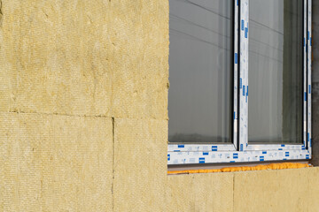 Layer of thermal insulation on the wall of the house outside. Mineral wool panels.