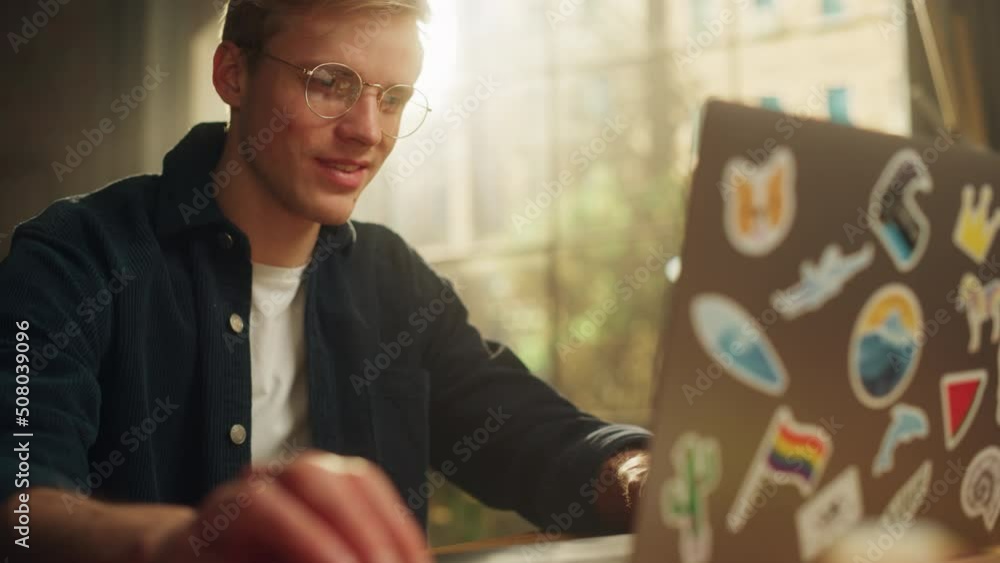 Poster Focused Male Software Engineer Codding on Laptop Computer while Working with Inspiration in Modern Loft Flat. Modern Man Creating Something New. Modern Freelancer at Remote Work Concept