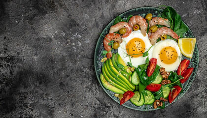 shrimps, prawns, soft fried egg, fresh salad, tomatoes, cucumbers and avocado on a dark background. Ketogenic diet breakfast. Keto, paleo lunch. Long banner format. top view