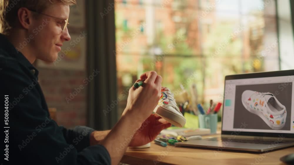 Aufkleber blonde male artist designing hand crafted shoe in front of laptop computer with 3d model on screen a