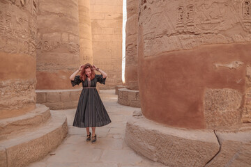 Woman between the pillars in the temple of Karnak in Luxor.