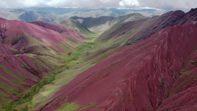 Aerial landscape of Rainbow Mountain Peak at Vinicunca Valley in Peru. A mountain with intense red, yellow, orange, green and blue colors. Red Valley. Scenic view of idyllic landscape.