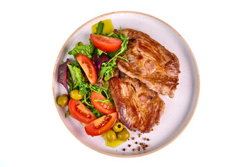Grilled pork shoulder steak with vegetable salad, isolated on white background.