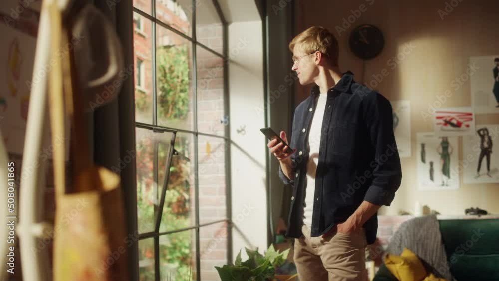 Leinwandbilder caucasian man using smartphone while resting at home. happy male blogger creating content and chatti