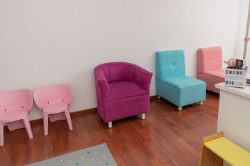 Colored armchairs in the waiting room of a pediatric office