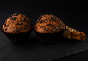 Chocolate cupcakes on a brown plate. Homemade fluffy chocolate cupcakes. Cupcakes with chocolate and cinnamon